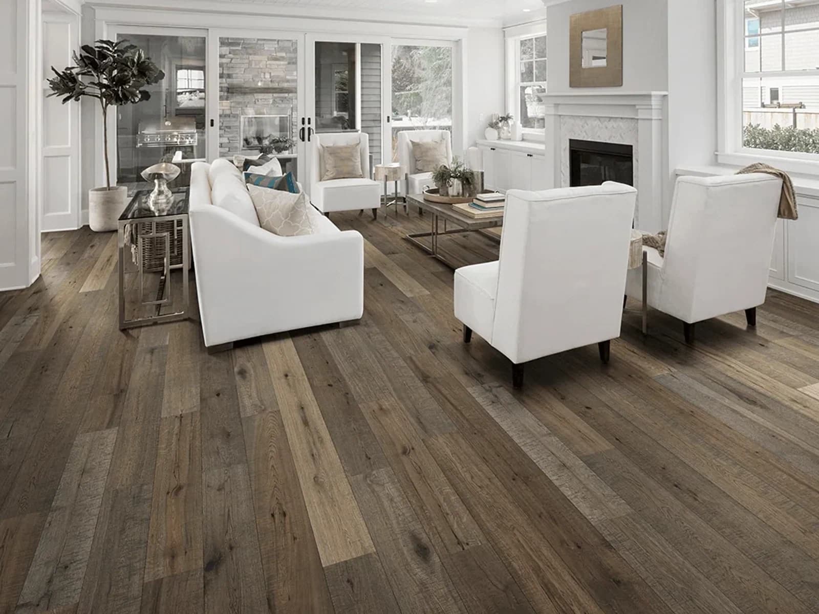 Bright living room seating group on exposed hardwood before a rug preview
